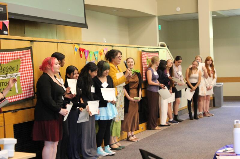 The 2026 Hatfield Futures Showcase winning teams. On the left is the winning team, The Horizon Project, and the two runner-up teams are on the right: the Corvallis team and the Illinois Valley team. In between the teams stands Wendy Willis, director of Oregon's Kitchen Table, and Marta Tarantsey, one of the judges.